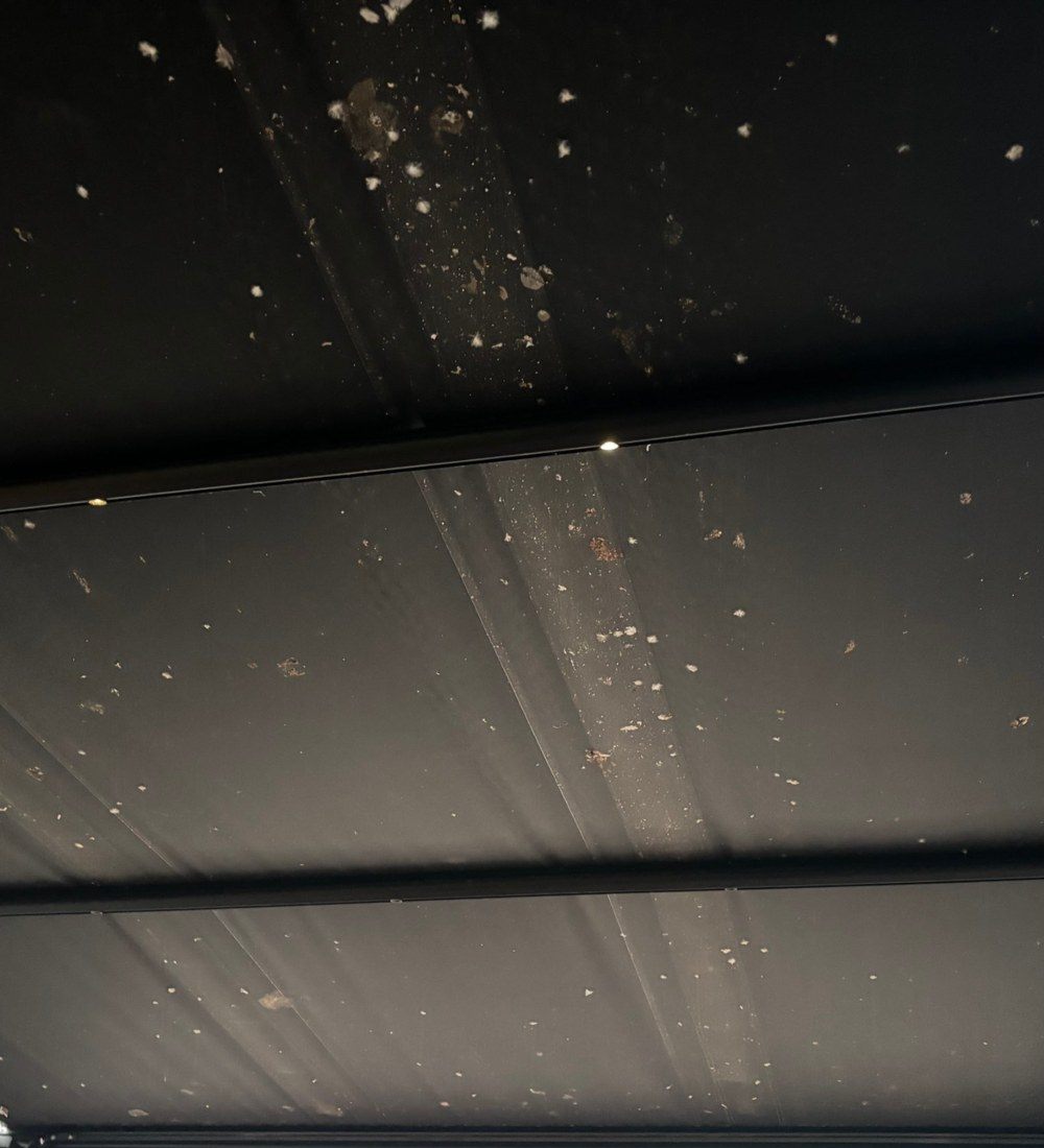 Sous-face d'une bâche de terrasse tachée avant le nettoyage